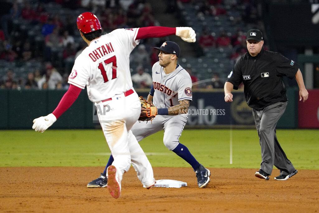 Mark J. Terrill Los Angeles Angels designated hitter Shohei Ohtani, left, steals second as Houston Astros shortstop Carlos Correa, center, waits for the throw while second base umpire Todd Tichenor watches during the sixth inning of a baseball game Thursday, Sept. 23, 2021, in Anaheim, Calif. (AP Photo/Mark J. Terrill)
