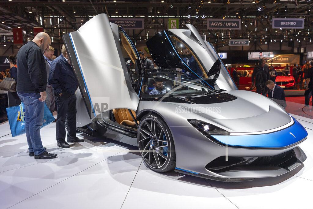 Martial Trezzini Visitors look at the new Automobili Pininfarina 'Battista' during the press day at the '89th Geneva International Motor Show' in Geneva, Switzerland, Tuesday, March 05, 2019. The 'Geneva International Motor Show' takes place in Switzerland from March 7 until March 17, 2019. Automakers are rolling out new electric and hybrid models at the show as they get ready to meet tougher emissions requirements in Europe - while not forgetting the profitable and popular SUVs and SUV-like crossovers. (Martial Trezzini/Keystone via AP)