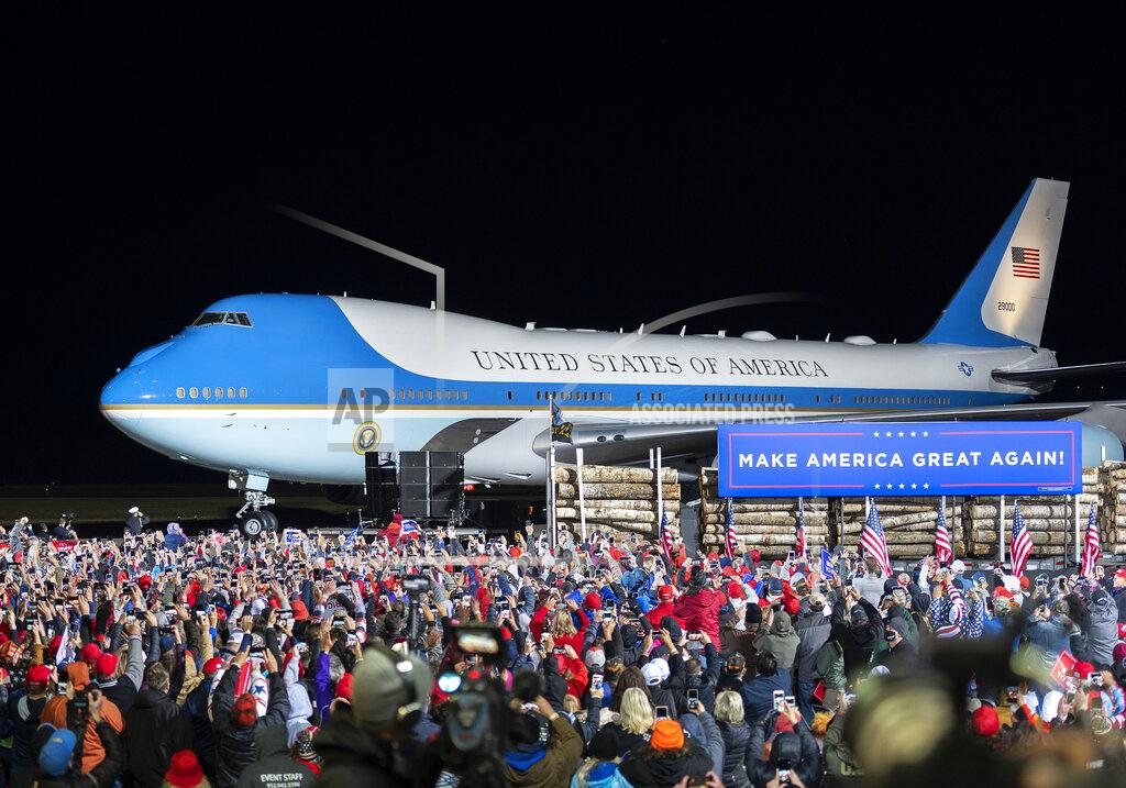 The crowd cheers as Air Force One arrives with President Donald Trump at Duluth International Airport on Wednesday, Sept. 30, 2020, for Trump's campaign appearance in Duluth, Minn. (AP Photo/Jack Rendulich)