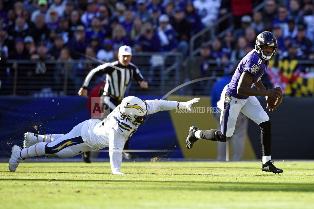 Gail Burton Baltimore Ravens quarterback Lamar Jackson, right, rushes past Los Angeles Chargers defensive tackle Justin Jones in the first half of an NFL wild card playoff football game, Sunday, Jan. 6, 2019, in Baltimore. (AP Photo/Gail Burton)