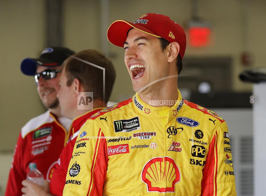 Chuck Burton Joey Logano shares a laugh with team members before practice for Saturday's NASCAR All-Star Cup series auto race at Charlotte Motor Speedway in Concord, N.C., Friday, May 17, 2019. (AP Photo/Chuck Burton)