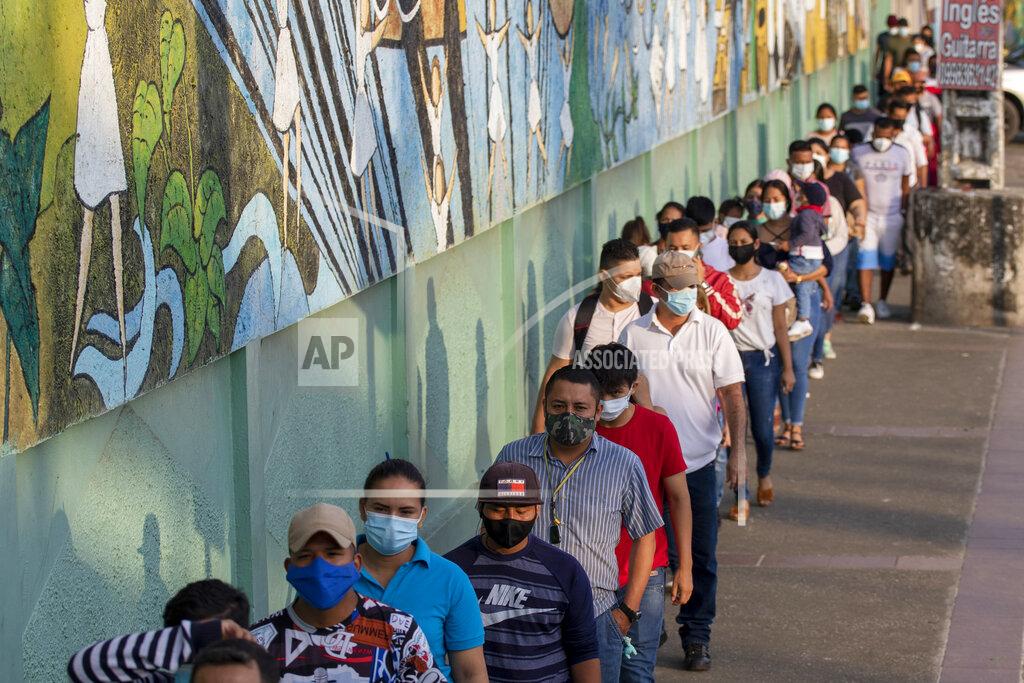 Angel Dejesus Voters line up at a polling station during a presidential runoff election in Guayaquil, Ecuador, Sunday, April 11, 2021. (AP Photo/Angel Dejesus)