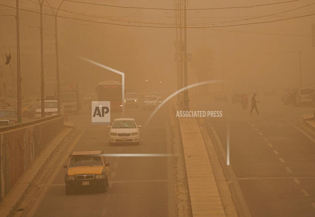 Hadi Mizban People drive vehicles on a street during a sandstorm in Baghdad, Iraq, Monday, May 23, 2022. (AP Photo/Hadi Mizban)