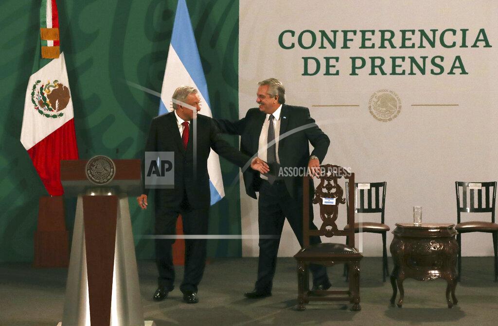 Marco Ugarte Argentina's President Alberto Fernández, right, arrives with Mexican President Andrés Manuel López Obrador for the Mexican president's daily, morning press conference at the National Palace in Mexico City, Tuesday, Feb. 23, 2021. Fernández is on a four-day official visit to Mexico. (AP Photo/Marco Ugarte)