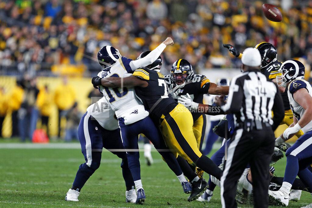 Keith Srakocic CORRECTS TO FUMBLE, INSTEAD OF INTERCEPTION - Los Angeles Rams quarterback Jared Goff (16) is hit by Pittsburgh Steelers nose tackle Javon Hargrave (79), fumbling the ball, which Minkah Fitzpatrick returned for a touchdown during the first half of an NFL football game in Pittsburgh, Sunday, Nov. 10, 2019. (AP Photo/Keith Srakocic)