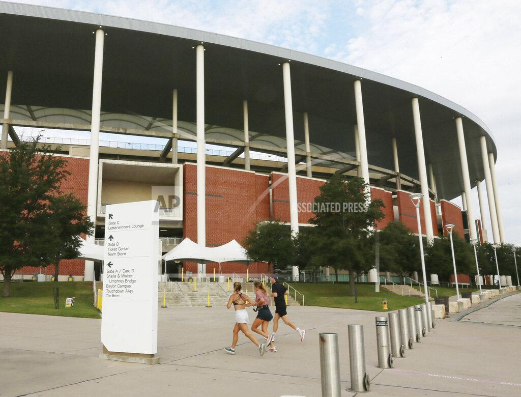 Rod Aydelotte Baylor students jog past Baylor University's McLane Stadium, Thursday, Sept. 17, 2020, in Waco, Texas. Baylor’s season opener against Houston, scheduled less than a week ago, was one of two FBS NCAA college football games postponed Friday, Sept. 18, 2020, the day before before they were supposed play. (Rod Aydelotte/Waco Tribune-Herald via AP)