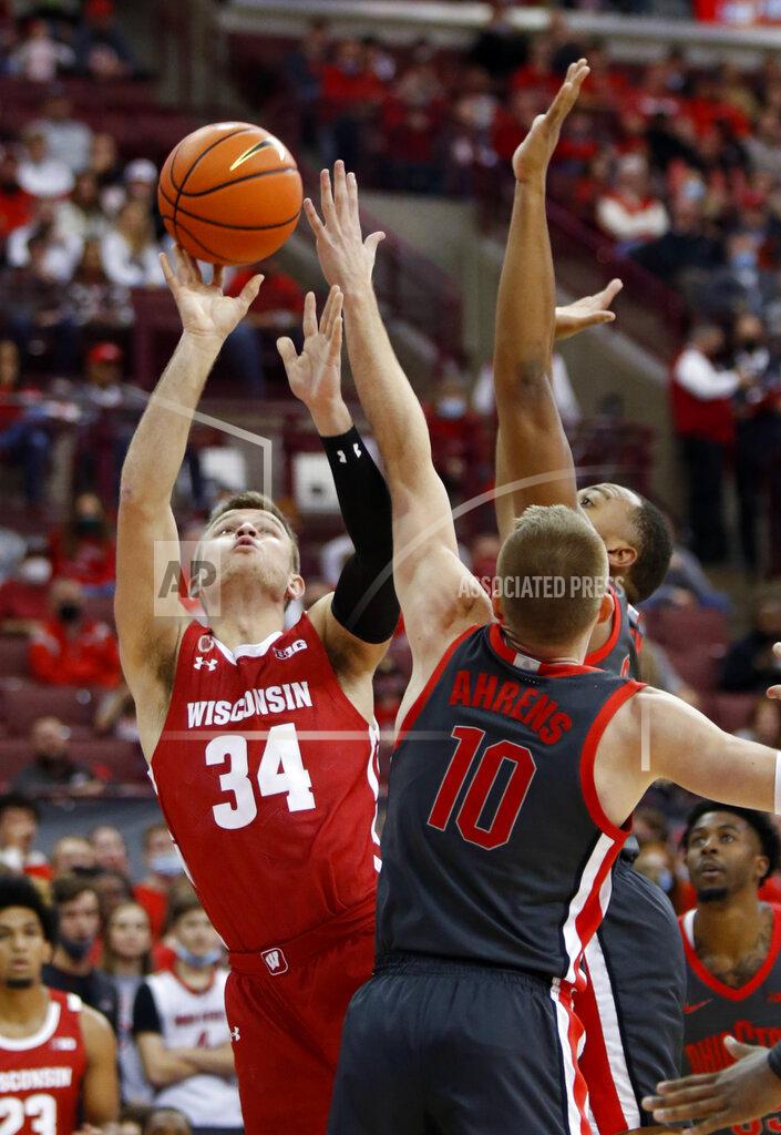 Paul Vernon Wisconsin guard Brad Davison, left, goes up for a shot in front of Ohio State forward Justin Ahrens, center, and forward Zed Key during the first half of an NCAA college basketball game in Columbus, Ohio, Saturday, Dec. 11, 2021. (AP Photo/Paul Vernon)