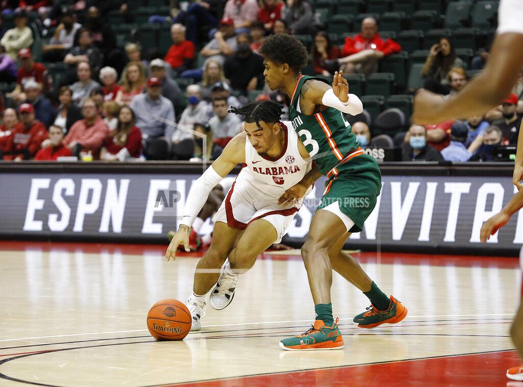 Jacob M. Langston Alabama guard Jaden Shackelford drives against Miami guard Kameron McGusty during the first half of an NCAA college basketball game Sunday, Nov. 28, 2021, in Lake Buena Vista, Fla. (AP Photo/Jacob M. Langston)