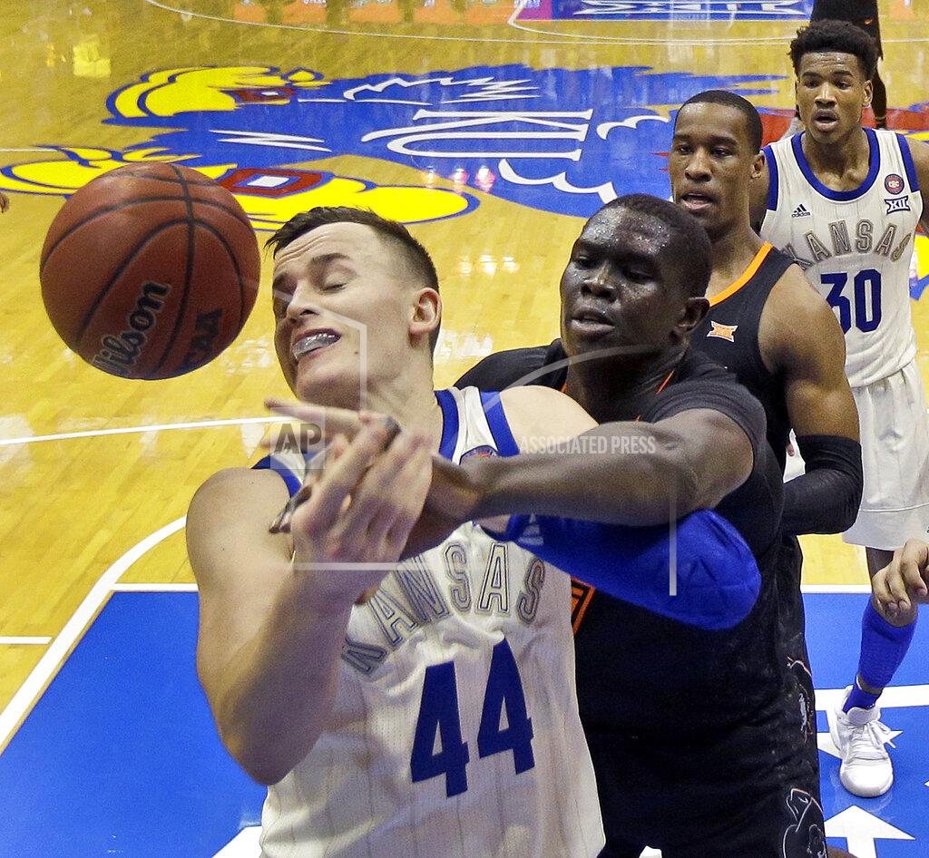 Charlie Riedel Kansas' Mitch Lightfoot (44) and Oklahoma State's Yor Anei battle for a rebound during the second half of an NCAA college basketball game Saturday, Feb. 9, 2019, in Lawrence, Kan. Kansas won 84-72. (AP Photo/Charlie Riedel)