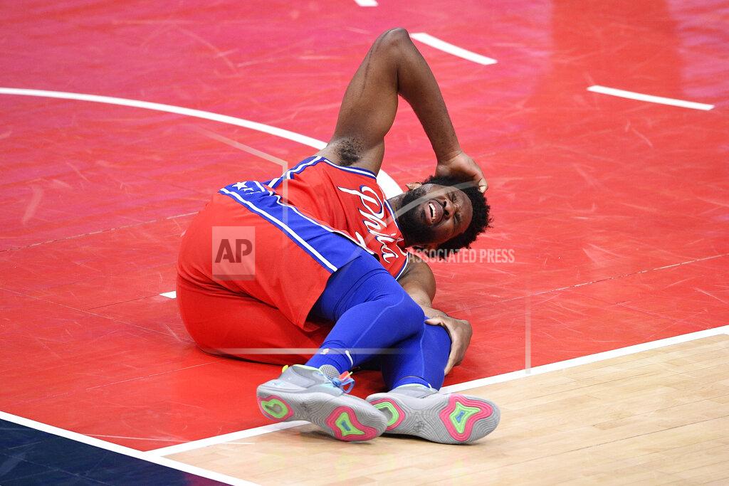 Nick Wass Philadelphia 76ers center Joel Embiid (21) reacts after an injury during the second half of the team's NBA basketball game against the Washington Wizards, Friday, March 12, 2021, in Washington. (AP Photo/Nick Wass)