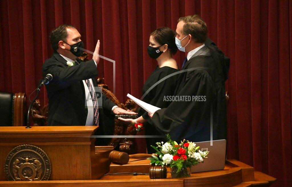 Laurie Skrivan State Rep. Rob Vescovo, R-Arnold, places his hand on the bible held by his wife Amanda as he takes the Oath for Speaker of the House on Wednesday, Jan. 6, 2021, at the Capitol in Jefferson City, Mo. (Laurie Skrivan/St. Louis Post-Dispatch via AP)