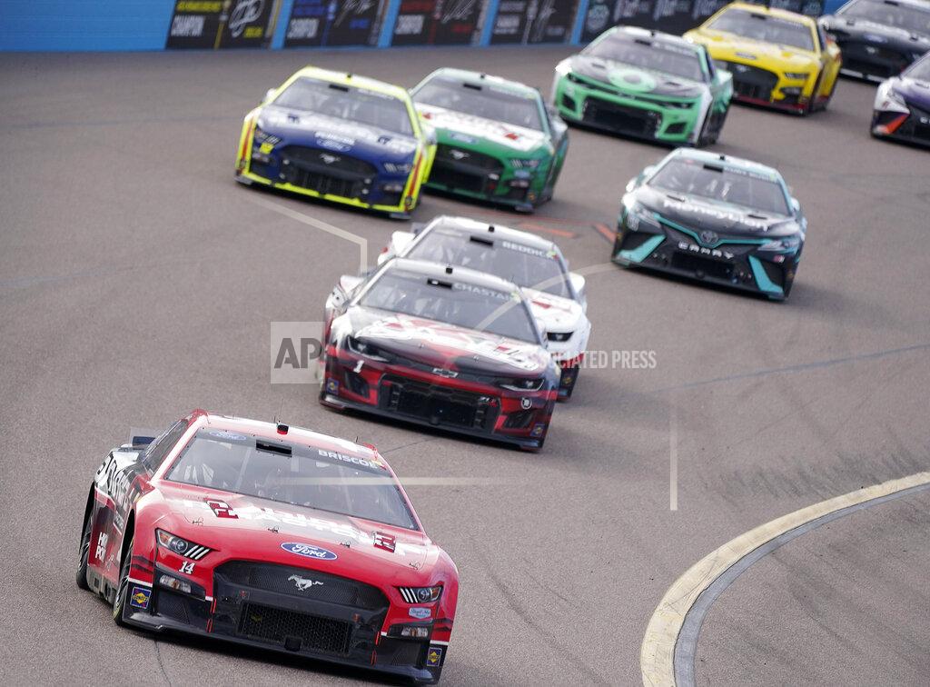 Darryl Webb Chase Briscoe (14) leads late in a NASCAR Cup Series auto race at Phoenix Raceway, Sunday, March 13, 2022, in Avondale, Ariz. (AP Photo/Darryl Webb)