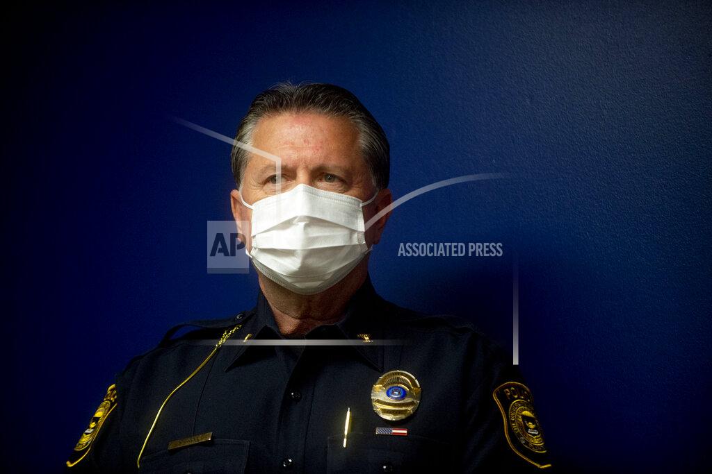 Jake May | Mlive.com Ray Hall, UM-Flint public safety director, stands with a mask on as Genesee County Prosecutor David Leyton details the shooting resulting in the death of Calvin Munerlyn during a press conference on Monday, May 4, 2020 at the Genesee County Prosecutor's Office in Flint. (Jake May /The Flint Journal via AP)