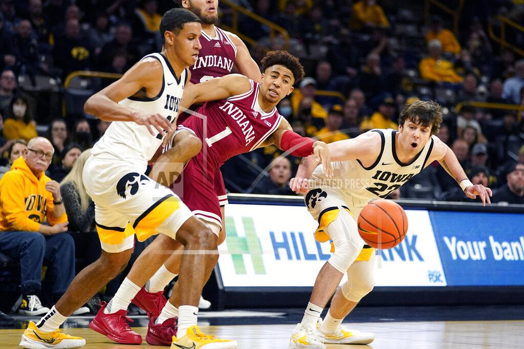 Charlie Neibergall Indiana guard Rob Phinisee (1) loses the ball between Iowa forward Kris Murray, left, and forward Patrick McCaffery, right, during the first half of an NCAA college basketball game, Thursday, Jan. 13, 2022, in Iowa City, Iowa. (AP Photo/Charlie Neibergall)