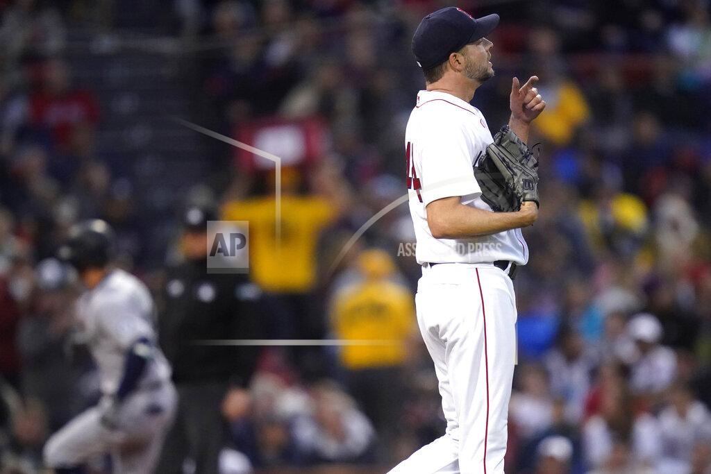 Charles Krupa Boston Red Sox starting pitcher Rich Hill, right, heads back to the mound after giving up a three-run home run to Seattle Mariners' Dylan Moore, left, during the second inning of a baseball game against the Boston Red Sox at Fenway Park, Thursday, May 19, 2022, in Boston. (AP Photo/Charles Krupa)