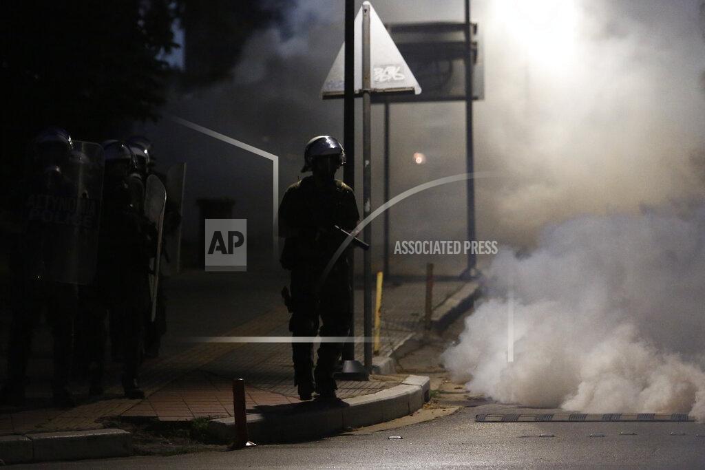 Giannis Papanikos Riot police officers operate during a protest at the University of Thessaloniki in northern Greece, Thursday, May 26, 2022. Earlier Thursday, the protesters faced off with police inside the city's main university campus, where unrest has been bubbling for weeks over a left-wing squat that was closed down. (AP Photo/Giannis Papanikos)