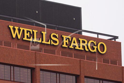 Shown is a Wells Fargo location in Philadelphia, Tuesday, Oct. 12, 2021. Wells Fargo easily beat Wall Street targets, Friday, Jan. 14, 2022, in the fourth quarter, just as interest rates appear poised to take off and further boost the nation’s largest mortgage lender. (AP Photo/Matt Rourke)