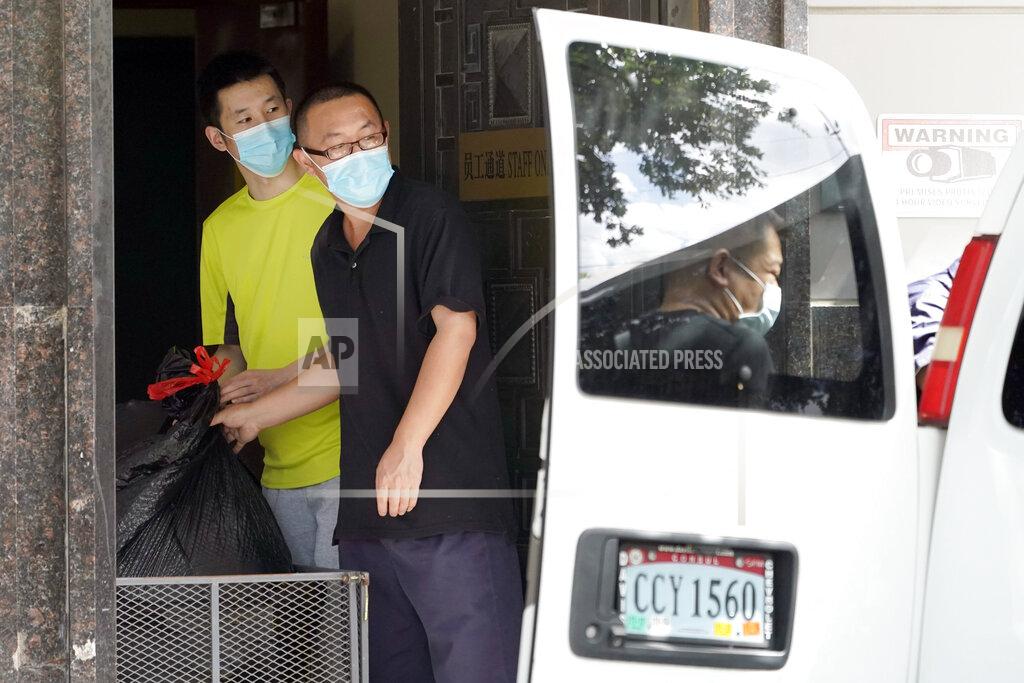 David J. Phillip People remove bags from inside the Chinese Consulate to load into a van Thursday, July 23, 2020, in Houston. China says “malicious slander" is behind an order by the U.S. government to close its consulate in Houston, and maintains that its officials have never operated outside ordinary diplomatic norms. (AP Photo/David J. Phillip)