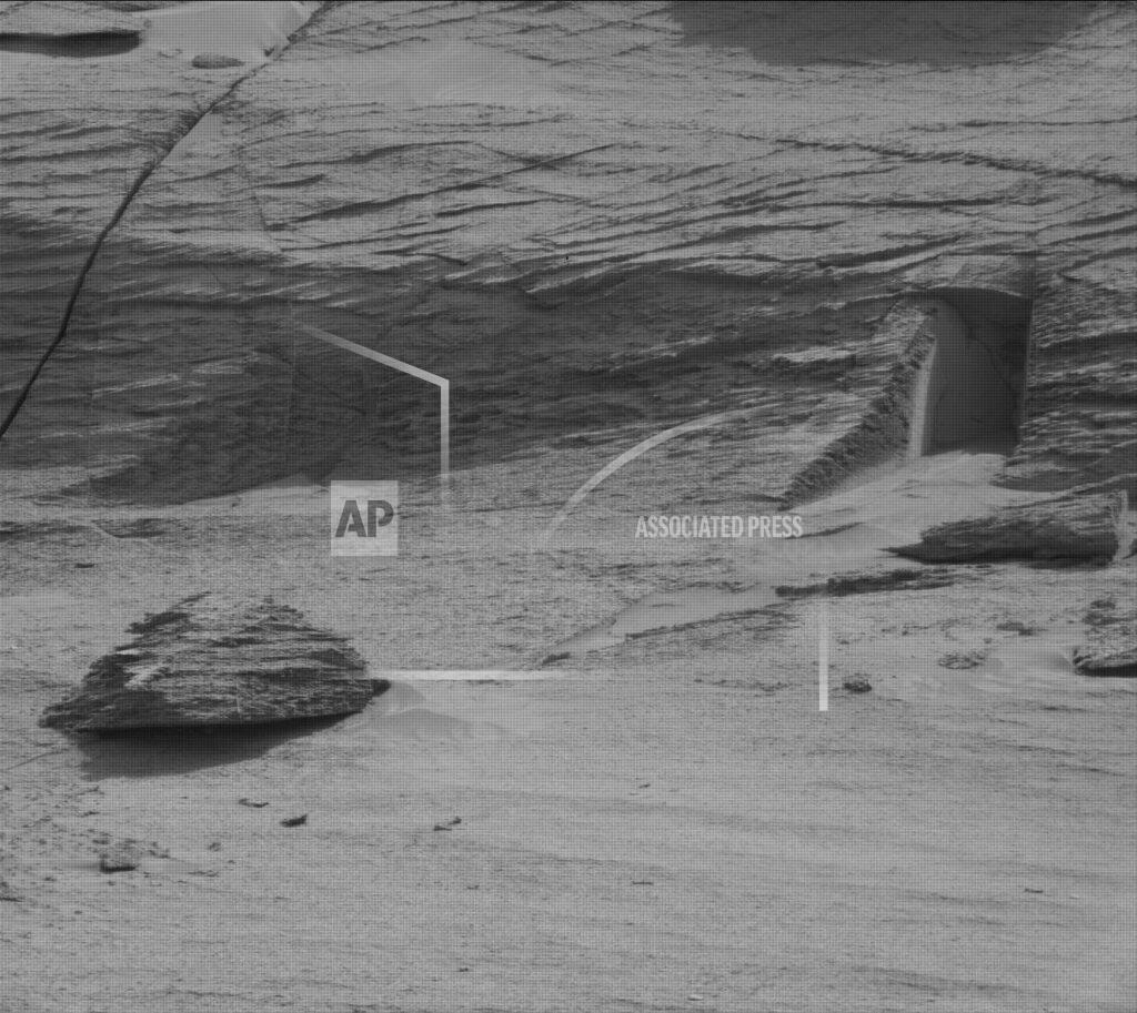 Uncredited This image made available by NASA was taken by the Mast Camera onboard NASA's Mars rover Curiosity on Sol 3466, May 7, 2022. On Friday, May 20, 2022, The Associated Press reported on stories circulating online incorrectly claiming NASA’s Mars rover has captured images of a doorway cut into a mountainside of the red planet, suggesting the presence of extraterrestrial life. (NASA/JPL-Caltech/MSSS via AP)