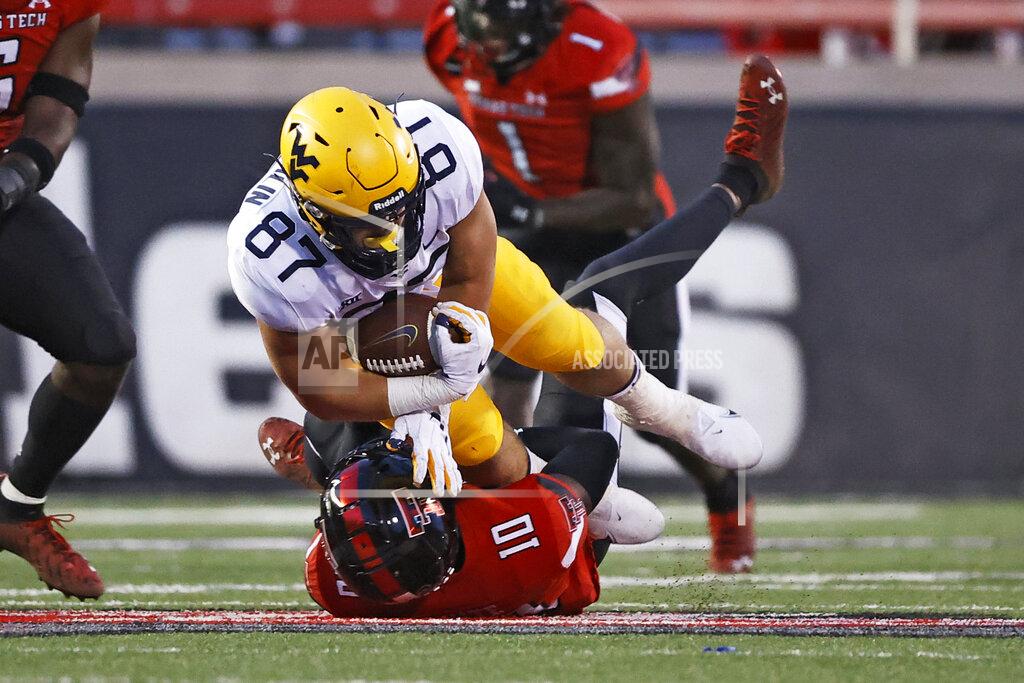 Brad Tollefson Texas Tech's Cam White (10) tackles West Virginia's Mike O'Laughlin (87) during the second half of an NCAA college football game on Saturday, Oct. 24, 2020, in Lubbock, Texas. (AP Photo/Brad Tollefson)