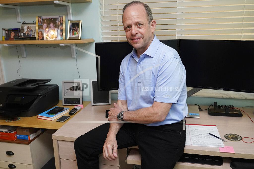 Marta Lavandier Mark Bendell sits at his home office, Monday, May 23, 2022, in Boca Raton, Fla. Americans on the cusp of retiring are facing a tough choice as they watch their nest eggs shrink: Stay the course or keep working. Despite the market's decline, investors like Bendell are sticking to their retirement timeline. (AP Photo/Marta Lavandier)
