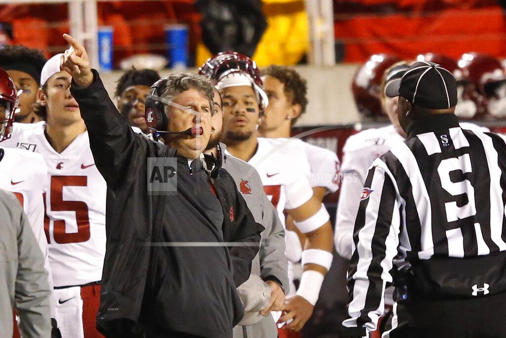 Washington State head coach Mike Leach speaks with a official in the first half of an NCAA college football game against Utah Saturday, Sept. 28, 2019, in Salt Lake City. (AP Photo/Rick Bowmer)