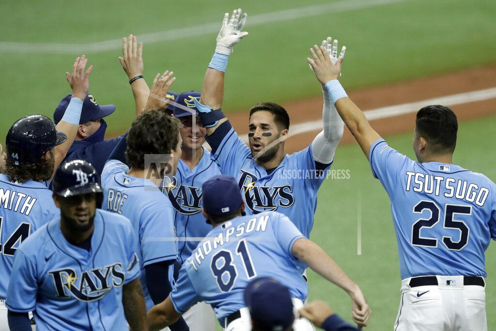 Chris O'meara CORRECTS TO TRIPLE, INSTEAD OF DOUBLE - Tampa Bay Rays' Kevin Kiermaier, second from right, celebrates with teammates, including Yoshitomo Tsutsugo, of Japan, after his two-run walk-off triple off Toronto Blue Jays relief pitcher Shun Yamaguchi during the 10th inning of a baseball game Sunday, July 26, 2020, in St. Petersburg, Fla. (AP Photo/Chris O'Meara)