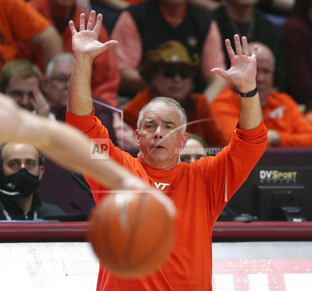 Matt Gentry Virginia Tech head coach Mike Young raises his arms on the sidelines during the first half of an NCAA college basketball game in Blacksburg, Va. Saturday, Dec. 4 2021. (Matt Gentry/The Roanoke Times via AP)