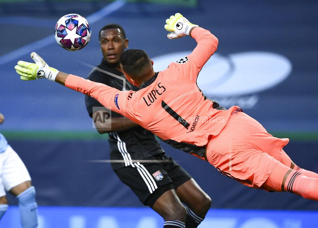 Franck Fife Lyon's goalkeeper Anthony Lopes dives to make a save during the Champions League quarterfinal match between Manchester City and Lyon at the Jose Alvalade stadium in Lisbon, Portugal, Saturday, Aug. 15, 2020. (Franck Fife/Pool Photo via AP)