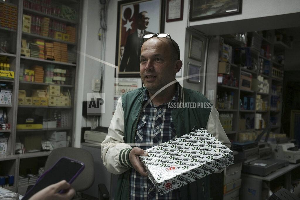 Burhan Ozbilici Caner Kazma speaks to The Associated Press in Ankara, Turkey, Wednesday, May 11, 2022. Kazma worries about the future of the stationary and office supply shop that he owns in partnership with his cousins. The dire economic outlook has forced many businesses in the area to cut back on office supplies. Meanwhile, Kazma says he struggles to replace items he has sold. (AP Photo/Burhan Ozbilici)
