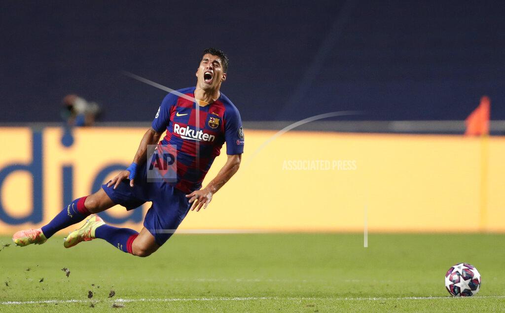 Manu Fernandez Barcelona's Luis Suarez grimaces after being fouled during the Champions League quarterfinal match between FC Barcelona and Bayern Munich at the Luz stadium in Lisbon, Portugal, Friday, Aug. 14, 2020. (AP Photo/Manu Fernandez/Pool)