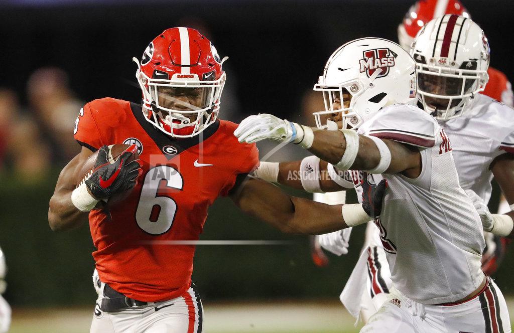 John Bazemore Georgia running back James Cook (6) fends off Massachusetts safety Brice McAllister (2) during the second half of an NCAA college football game Saturday, Nov. 17, 2018, in Athens, Ga. (AP Photo/John Bazemore)