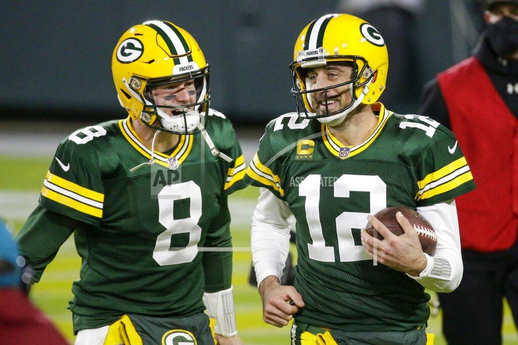 Mike Roemer Green Bay Packers' Aaron Rodgers celebrates a touchdown pass with Tim Boyle (8) during the second half of an NFL football game against the Philadelphia Eagles Sunday, Dec. 6, 2020, in Green Bay, Wis. The pass was Rodgers' 400th career touchdown pass. (AP Photo/Mike Roemer)
