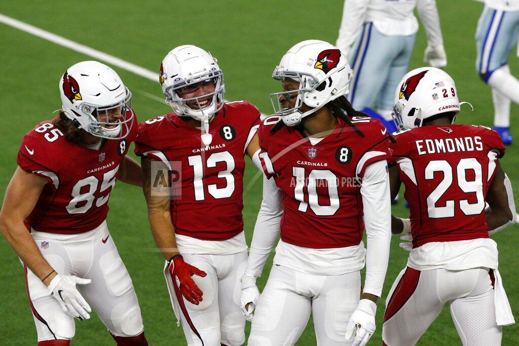 Michael Ainsworth Arizona Cardinals' Dan Arnold (85), Christian Kirk (13), DeAndre Hopkins (10) and Chase Edmonds (29) celebrate a long catch and run by Hopkins in the second half of an NFL football game against the Dallas Cowboys in Arlington, Texas, Monday, Oct. 19, 2020. (AP Photo/Michael Ainsworth)