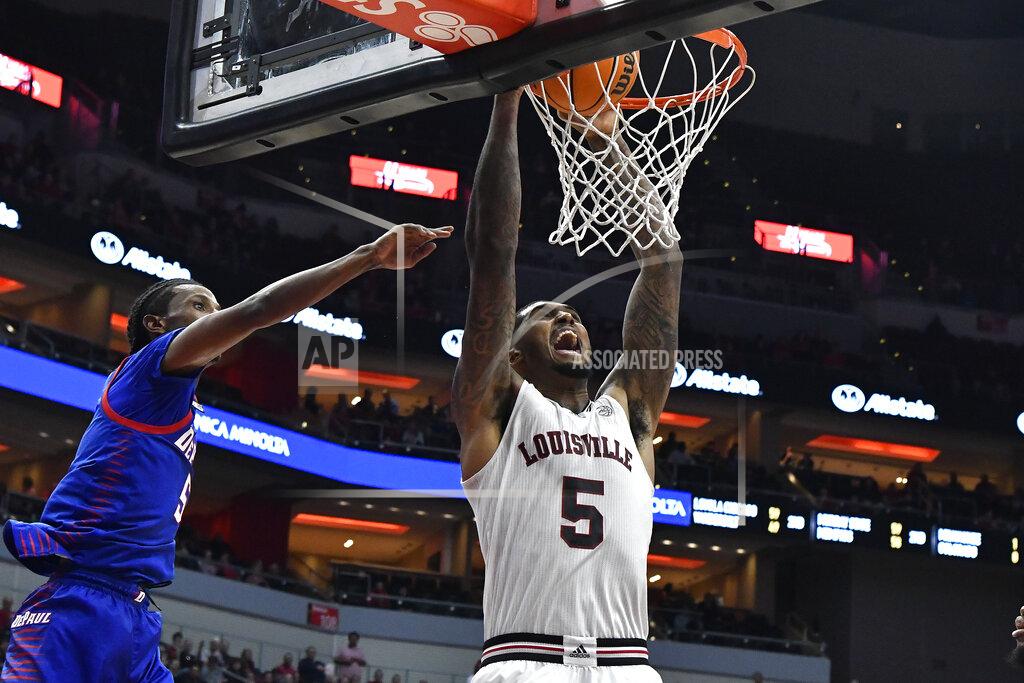 Timothy D. Easley Louisville forward Malik Williams (5) dunks next to DePaul guard Philmon Gebrewhit (5) during the second half of an NCAA college basketball game in Louisville, Ky., Friday, Dec. 10, 2021. (AP Photo/Timothy D. Easley)