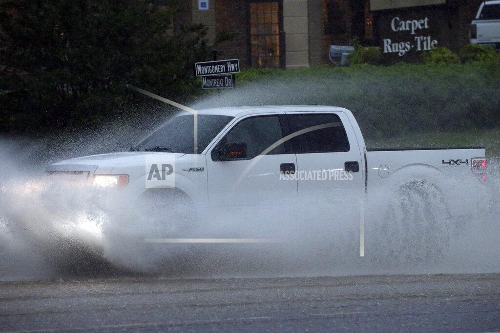 Butch Dill A pickup truck travels along a flooded road as severe weather produces torrential rainfall, Tuesday, May 4, 2021 in Vestavia, Ala. (AP Photo/Butch Dill)