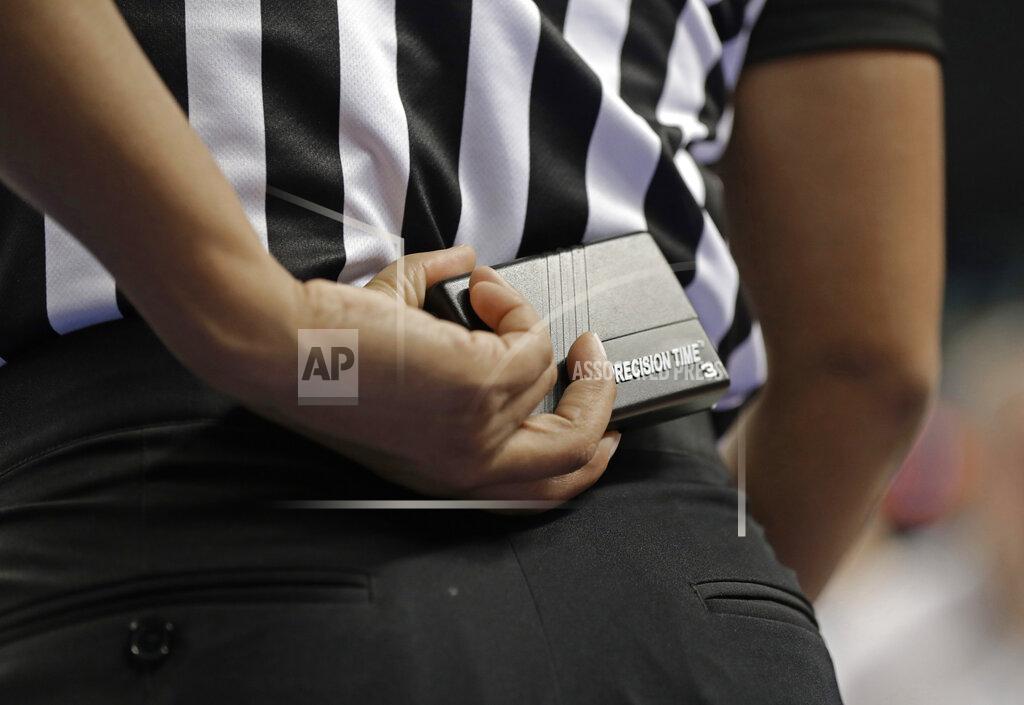 Chuck Burton In this photo taken March 8, 2019, a referee prepares to start a play using a Precision Time device during the first half of an Atlantic Coast Conference women's tournament basketball game in Greensboro, N.C. The Precision Time system created more than two decades ago by former referee Mike Costabile currently is used at nearly every level of the sport, including the NBA and college basketball's NCAA Tournament. Costabile estimates the ability to stop the clock automatically on a referee's whistle can save roughly 90 seconds formerly lost to reaction time when timekeepers manually stopped the clock. (AP Photo/Chuck Burton)