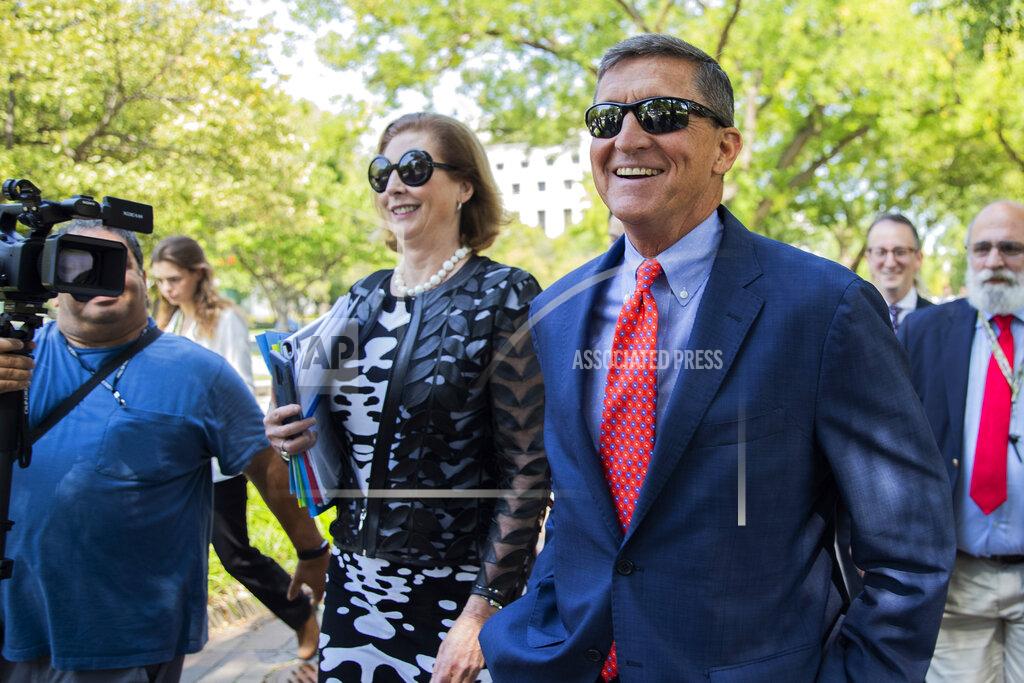 Manuel Balce Ceneta FILE - In this Sept. 10, 2019, file photo, Michael Flynn, President Donald Trump's former national security adviser from Middletown, R.I., leaves federal court with his lawyer Sidney Powell, left, following a status conference in Washington. On Nov. 25, 2020, Trump pardoned Flynn despite Flynn's guilty plea to lying to the FBI about his Russia contacts. (AP Photo/Manuel Balce Ceneta, File)