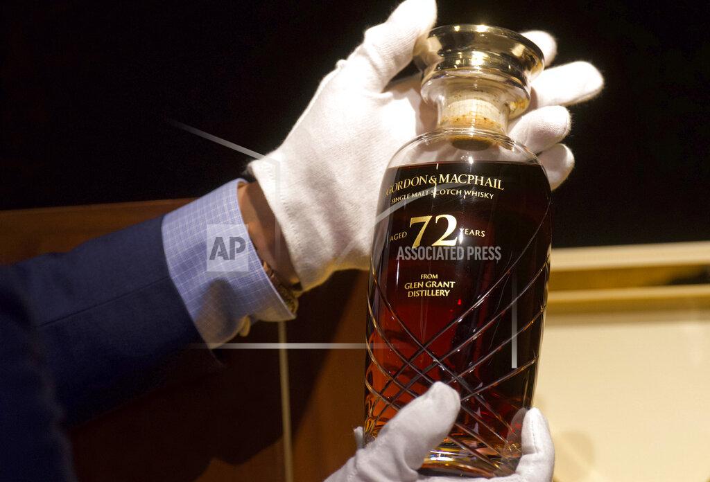 Vincent Yu Expecting to fetch up to US$49,000 at auction, a 72-year-old bottle of Glen Grant single malt whisky from Scotland is displayed at a Bonhams auction preview in Hong Kong, Thursday, Jan. 28, 2021. Despite the economic uncertainty brought on by the pandemic, interest in the rare whisky remains high. Compared to other investment commodities, collectable whisky is doing strong in the past 10 years, with a four-fold increase in its price, Bonhams specialist Christopher Pong said. (AP Photo/Vincent Yu)