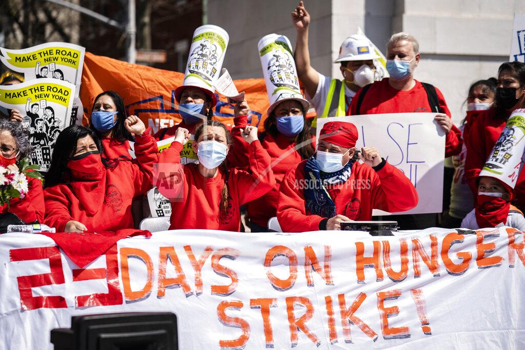 John Minchillo Demonstrators chant as they declare victory and celebrate the passage of the New York state budget with the ending their hunger strike that lasted 23 days, Wednesday, April 7, 2021, in the Manhattan borough of New York. New Yorkers, regardless of immigration status, could apply for help from a new $2.4 billion rental relief program that will offer 12 months of overdue rent and utilities, three prospective months of rent and a year of eviction protection. (AP Photo/John Minchillo)