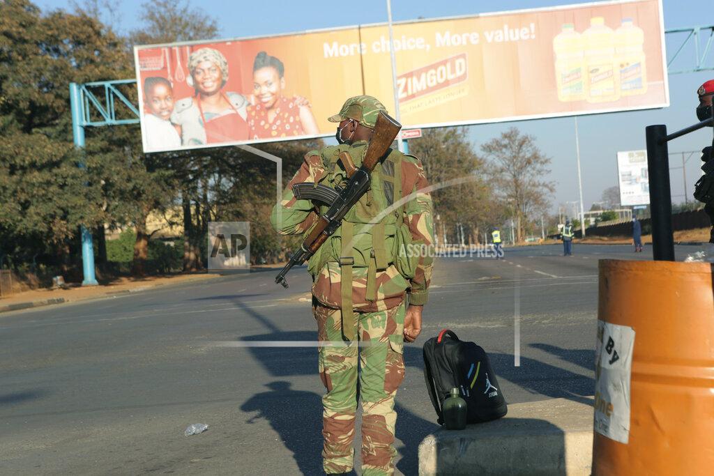 Tsvangirayi Mukwazhi An armed soldier stands on a deserted street in Harare, Friday, July, 31, 2020. Zimbabwe's capital, Harare, was deserted Friday, as security agents vigorously enforced the country's lockdown amidst planned protests. Police and soldiers manned checkpoints and ordered people seeking to get into the city for work and other chores to return home. (AP Photo/Tsvangirayi Mukwazhi)