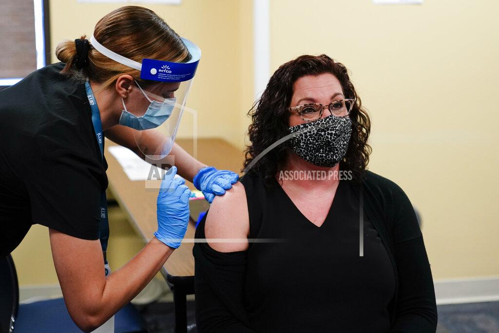 Matt Rourke Nurse Sara Muela, left, administers the Johnson & Johnson COVID-19 vaccine to educator Rebecca Titus at a vaccination site setup for teachers and school staff at the Berks County Intermediate Unit in Reading, Pa., Monday, March 15, 2021. (AP Photo/Matt Rourke)
