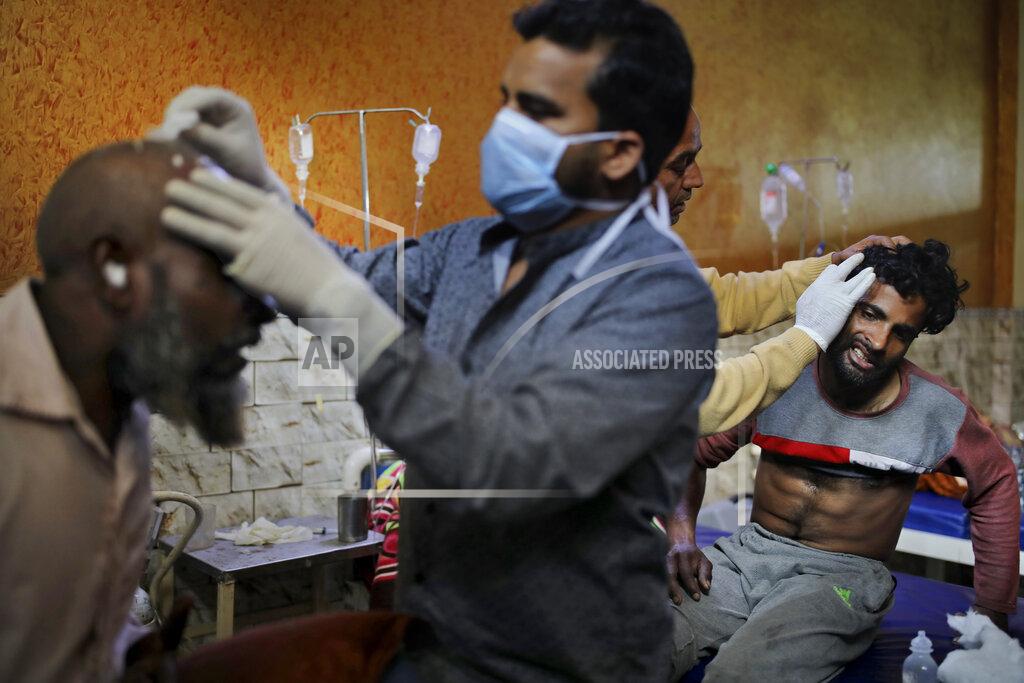 Altaf Qadri FILE - In this Friday, Feb. 28, 2020 file photo, paramedics tend to the wounds of Mehfooz Umar, left, and Mohammad Afzal at Al-Hind hospital in Old Mustafabad neighborhood of New Delhi, India. As the first anniversary of bloody communal riots that convulsed the Indian capital approaches, Muslim victims are still shaken and struggling to make sense of their struggle to seek justice. Many say they have run repeatedly into a refusal by police to investigate complaints made by Muslims against Hindu rioters. (AP Photo/Altaf Qadri, File)