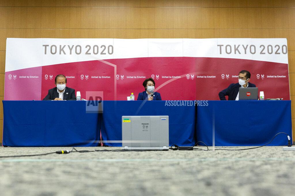 Yuichi Yamazaki Tokyo 2020 CEO Toshiro Muto, left, and President Seiko Hashimoto, center attend the news conference after receiving a report from a group of infectious disease experts on Friday, June 18, 2021, in Tokyo. The experts including Shigeru Omi, head of a government coronavirus advisory panel, issued a report listing the risks of allowing the spectators and the measurements to prevent the event from triggering a coronavirus spread. (Yuichi Yamazaki/Pool Photo via AP)