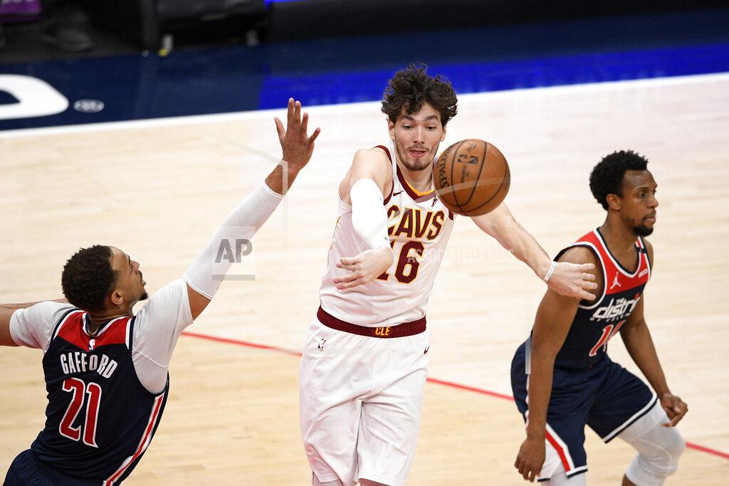 Nick Wass Cleveland Cavaliers forward Cedi Osman (16) passes the ball between Washington Wizards center Daniel Gafford (21) and guard Ish Smith, right, during the second half of an NBA basketball game Friday, May 14, 2021, in Washington. (AP Photo/Nick Wass)