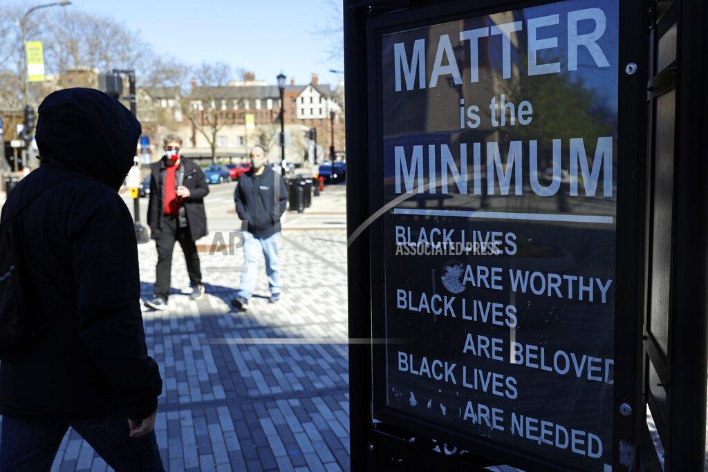Shafkat Anowar Pedestrians walk past a sign in Evanston, Ill., Friday, April 30, 2021. The Chicago suburb is preparing to pay reparations in the form of housing grants to Black residents who experienced housing discrimination. The city is being hailed as the first to do so, and is being held up as a model in its approach for other cities looking to do the same. (AP Photo/Shafkat Anowar)