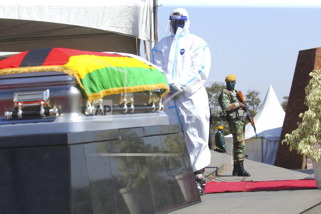 Tsvangirayi Mukwazhi An armed soldier stands guard during the burial of Zimbabwean minister Perence Shiri, who died of Covid-19, during his burial in Harare, Friday, July, 31, 2020. Zimbabwes capital, Harare, was deserted Friday, as security agents vigorously enforced the countrys lockdown amidst planned protests. (AP Photo/Tsvangirayi Mukwazhi)
