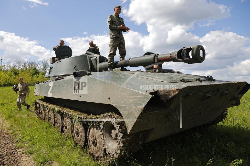 Alexei Alexandrov A crew of self-propelled artillery vehicles 'Gvozdika' ('Carnation') of Donetsk People's Republic militia prepare to fire towards Ukrainian army position, near the town of Yasynuvataya, outside Donetsk, in territory under the government of the Donetsk People's Republic, eastern Ukraine, Friday, May 20, 2022. (AP Photo/Alexei Alexandrov)