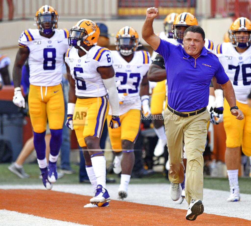 LSU coach Ed Orgeron takes the field with his players for an NCAA college football game against Texas on Saturday, Sept. 7, 2019, in Austin, Texas. (Hilary Scheinuk/The Advocate via AP)