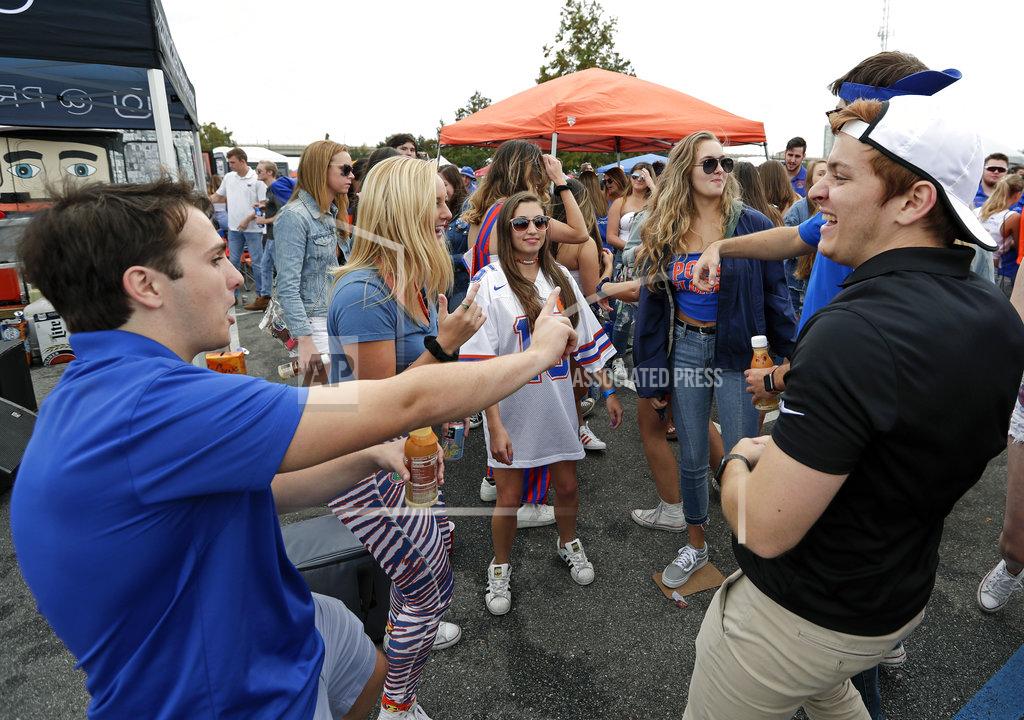 John Raoux Fans dance to music outside the stadium before an NCAA college football game between Florida and Georgia, Saturday, Oct. 27, 2018, in Jacksonville, Fla. (AP Photo/John Raoux)